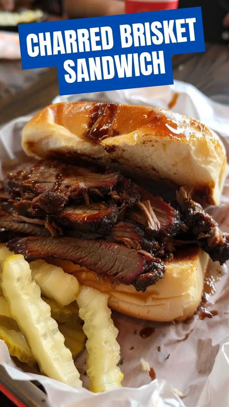 A deliciously messy BBQ brisket sandwich with tender meat and sauce.