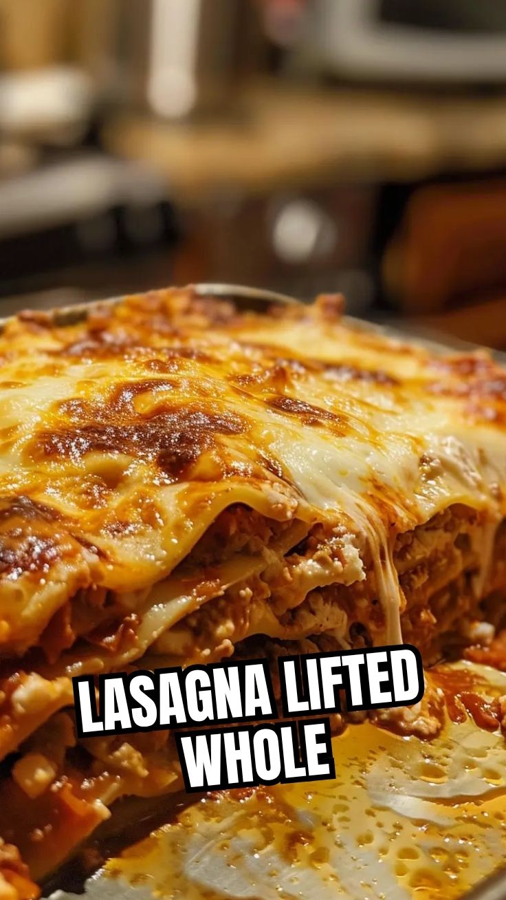 A steaming hot pan of freshly baked lasagna with melted cheese on top.