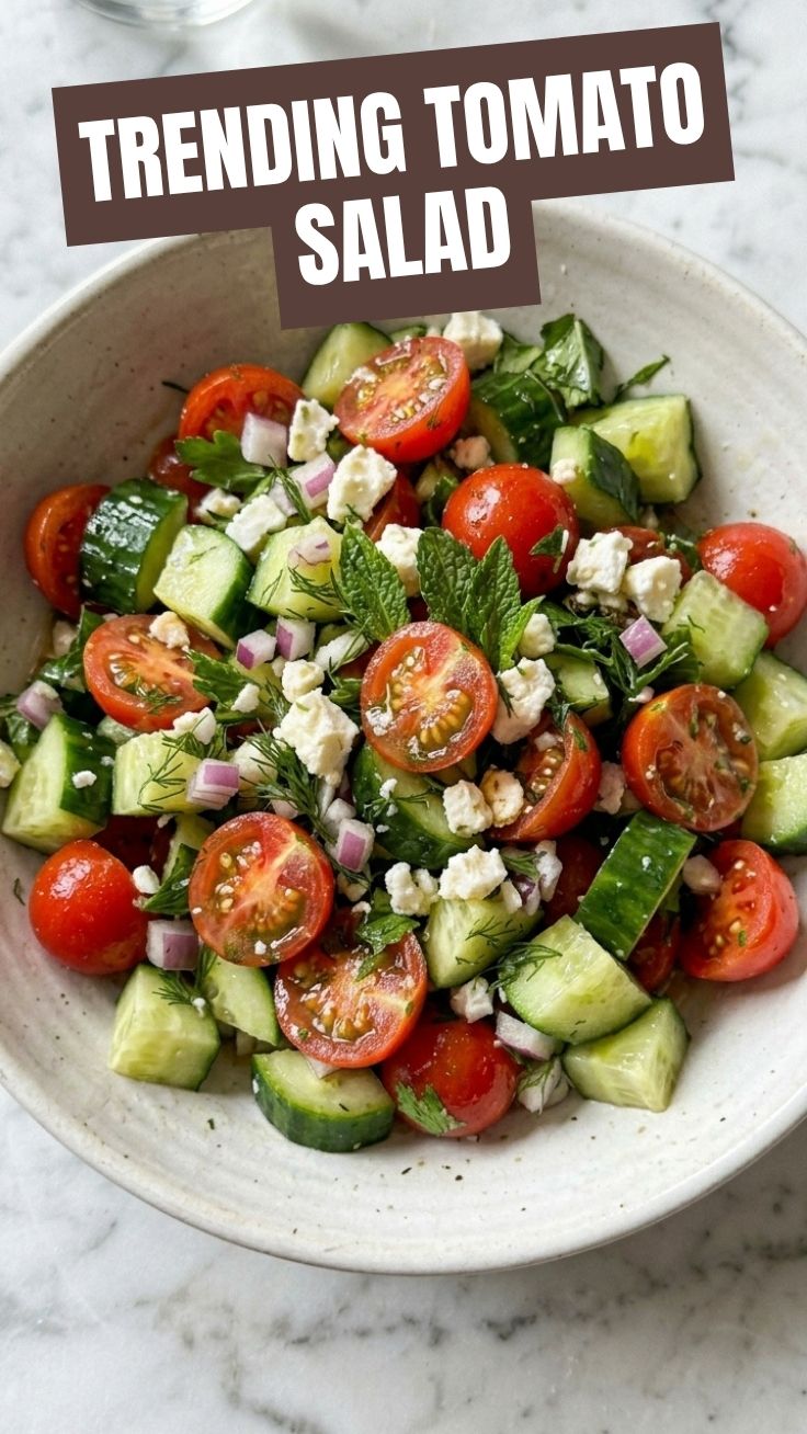 A fresh healthy cucumber tomato salad in a glass bowl, ready to serve.